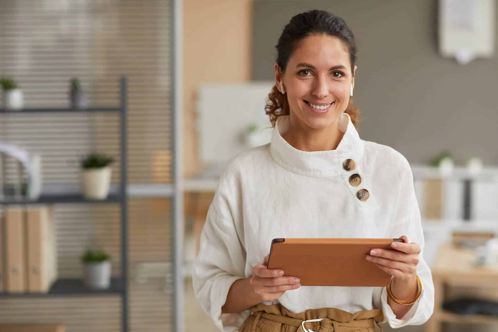 portrait-of-modern-businesswoman-holding-tablet-SWHSPWH.jpg